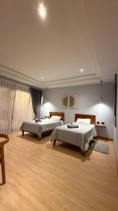 two beds in a large room with wooden floors at Private Pool Villa in Khao Lak +65 photos
