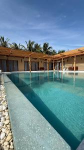 a swimming pool with blue water in front of a building at Private Pool Villa in Khao Lak