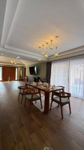a dining room with a table and two benches at Private Pool Villa in Khao Lak