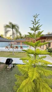 a tree in a yard next to a building at Private Pool Villa in Khao Lak