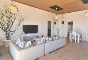 a living room with a couch and a tv at Fuerte Roche 2 in Tuineje