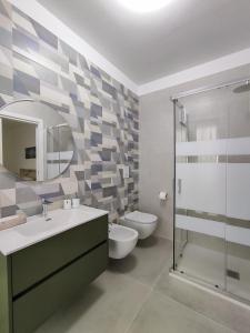 a bathroom with a toilet and a sink and a shower at Ad un passo dal mare apartment in Molfetta +24 photos
