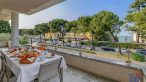 a table with food and a view of the ocean at Oscar Luxury Suite DesenzanoLoft Official Partner Homes & Villas by Marriott Bonvoy in Desenzano del Garda