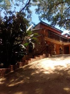 a brick house with a tree in front of it at Mountain Guesthouse in Pretoria