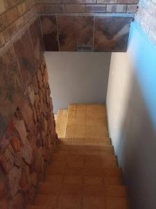 a staircase in a room with a stone wall at Mountain Guesthouse in Pretoria +71 photos