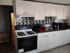 a kitchen with a black and white stove top oven at Grove 125 in Irvington