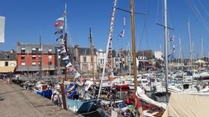 a bunch of boats docked in a harbor with buildings at le Questel in Plouézec