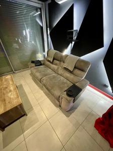 a couch sitting in the middle of a room at L unique Cinéma Room in Grenoble +12 photos