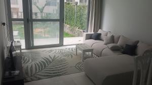 a living room with a couch and a large window at رويال جاردن سويت in Cairo +54 photos