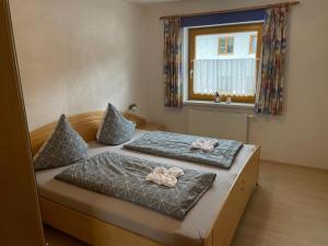 a bedroom with two beds with bows on them at Haus Alpenblick in Bichlbach