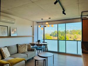 a living room with a couch and a table and chairs at Skyline Heaven - Fantastic View - Pool - Garage in Vila Nova de Gaia