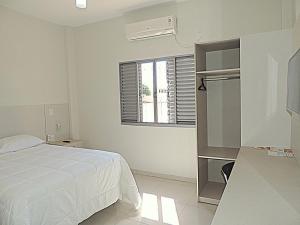 a white bedroom with a bed and a window at Pousada Gran-Café in Quixadá