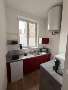 a small kitchen with a sink and a window at LB studio in Dunkerque