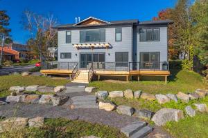 a large house with a porch and a yard at charming riverside retreat in Huntsville