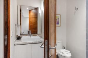 a bathroom with a sink and a toilet at Swim-up 1-bedroom apartment in Playa del Carmen