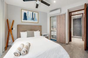 a bedroom with a large white bed with white sheets at Swim-up 1-bedroom apartment in Playa del Carmen +18 photos