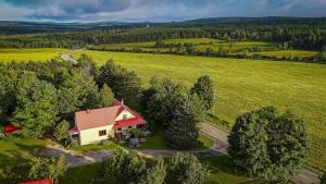 an aerial view of a house in the middle of a field at Camping de la Rivière Nicolet in Wotton