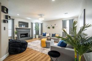 a living room with a couch and a fireplace at Stylish Oasis Modern Living in Allen