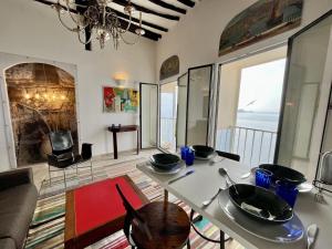 a living room with a table and a view of the ocean at Fleur de Falaise in Bonifacio +17 photos