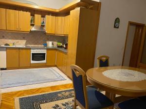 a kitchen with a table and a dining room at Villa Lana in Bihać