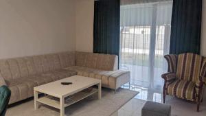 a living room with a couch and a coffee table at Harmony Apartman in Otilia