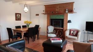a living room with a table and a fireplace at Cap 1 in Carneville