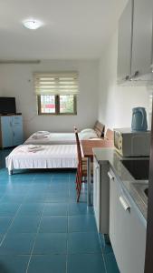 a kitchen and a bedroom with a bed in a room at Apart Ludmila in Bečići