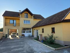 a house with a parking lot in front of it at Prenociste Pecinci in Pećinci