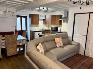 a living room with a couch and a kitchen at The Workshop in Aberystwyth