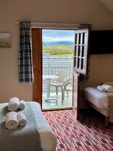a room with two beds and a view of a patio at The Workshop in Aberystwyth +57 photos