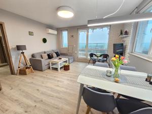 a living room with a table and chairs and a couch at Desitas home in Plovdiv