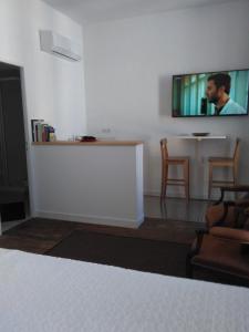 a living room with a flat screen tv on the wall at Aliénor in Bordeaux