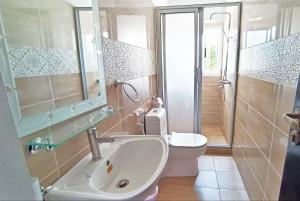 a bathroom with a sink and a toilet and a shower at Résidence Inspire in Douala