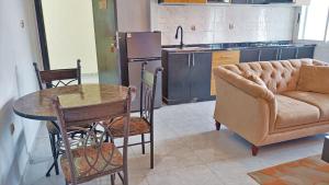 a living room with a table and a couch at Résidence Inspire in Douala
