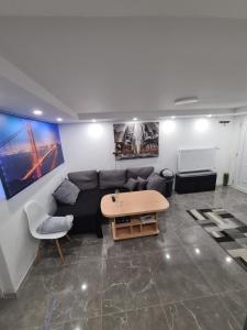 a living room with a couch and a table at Villa basement Apartment in Ennigerloh