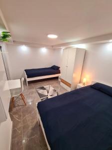 a bedroom with a blue bed and a desk at Villa basement Apartment in Ennigerloh