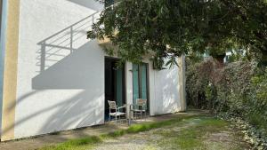 a pair of chairs sitting outside of a house at Apart Ludmila in Bečići