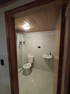 a bathroom with a toilet and a sink at Refugio rural MITA in Zipacón +22 photos