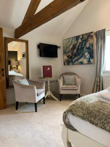 a bedroom with a bed and a desk and a chair at The Brosterfield Suite - Brosterfield Farm in Bakewell