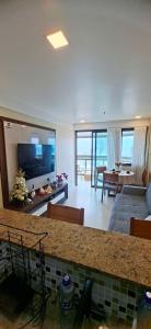a large living room with a couch and a television at Apartamento completo Premium-Frente ao Mar Wi-Fi rápido-ar-condicionado in Rio de Janeiro