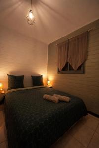 a bedroom with a bed with a black comforter at Là-Haut in Le Tampon +4 photos