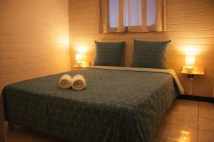 a bedroom with a bed with two towels on it at Là-Haut in Le Tampon