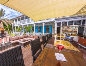 an outdoor patio with a table with a drink on it at Turks Head Inne in Grand Turk