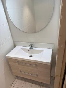 a bathroom with a sink and a mirror at Cozy Urban Escape in Otepää +6 photos