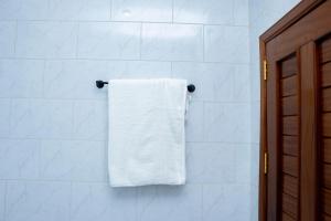 a towel hanging on a towel rack in a bathroom at Beza Residence in Ruhengeri +42 photos