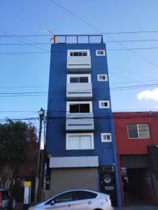 a blue building with a car parked in front of it at Mini suite in House or Varz hotel boutique in Tijuana +7 photos