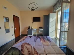 a bedroom with a large bed and a table at B&B Comfort Room 93 in Benevento