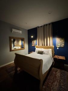 a bedroom with a large bed and a mirror at Yellowstone Hideaway in Livingston