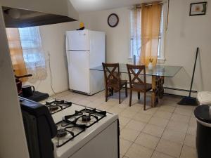 a kitchen with a white refrigerator and a table with chairs at Grove 125 in Irvington +23 photos
