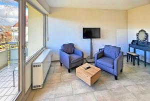 a living room with two chairs and a table at Hotel Schachener Hof in Lindau